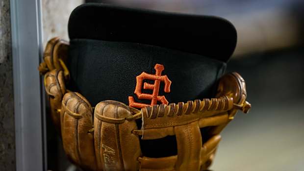 A SF Giants hat in a glove. (2022)