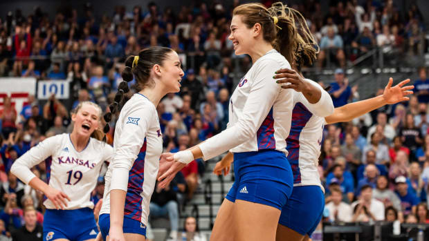 Kansas Jayhawk players celebrate after winning a point against the Texas Longhorns on Wednesday, September 21st, 2022.