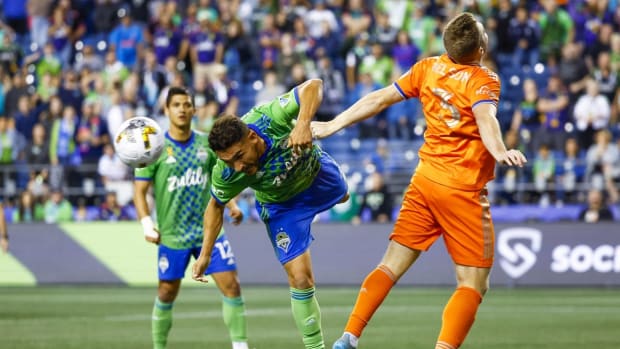 Sep 27, 2022; Seattle, Washington, USA; Seattle Sounders FC midfielder Cristian Roldan (7) misses a potential game-winning header against FC Cincinnati defender John Nelson (3) on the final play of the second half at Lumen Field. Mandatory Credit: Joe Nicholson-USA TODAY Sports
