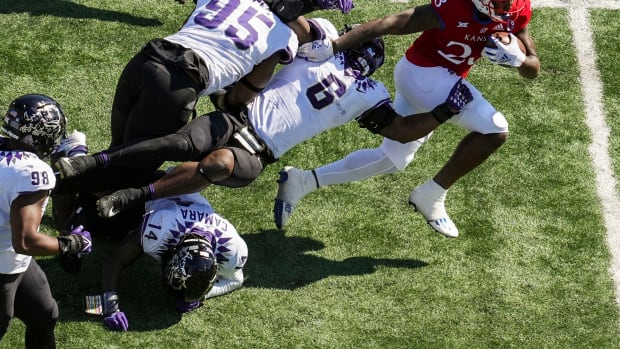 Oct 8, 2022; Lawrence, Kansas, USA; Kansas Jayhawks running back Sevion Morrison (28) runs past several TCU Horned Frogs during the first half at David Booth Kansas Memorial Stadium.