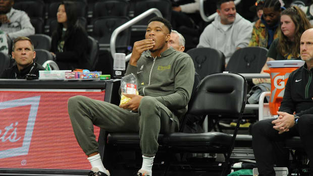 Milwaukee Bucks forward Giannis Antetokounmpo (34) eating popcorn while he watches the Milwaukee Bucks and Memphis Grizzlies game