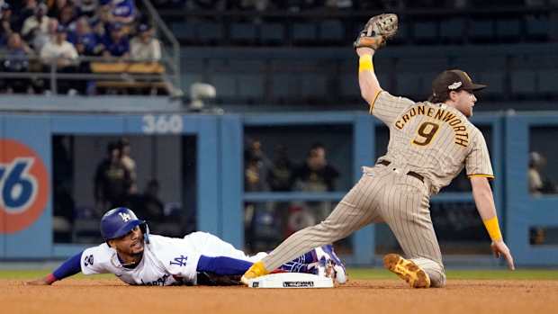 Jake Cronenworth shows his glove after tagging Mookie Betts, who was attempting to steal second base.