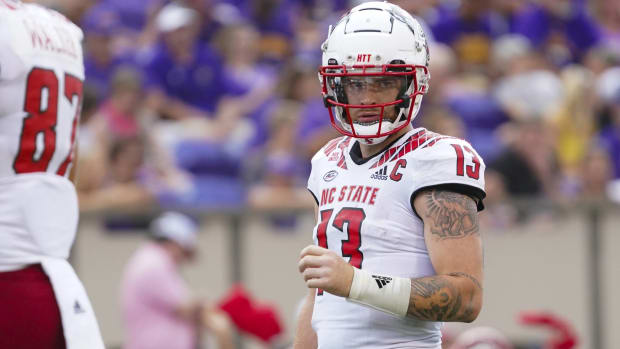 NC State quarterback Devin Leary looks to the sideline for a play during a game.