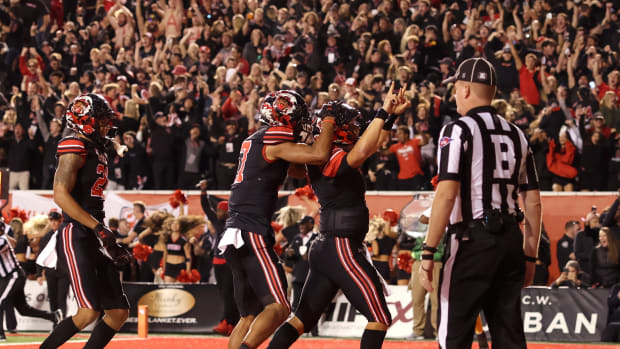 Utah Utes quarterback Cameron Rising (7) celebrates scoring a two-point conversation to take a one point lead against the USC Trojans in the final minute of the game at Rice-Eccles Stadium.