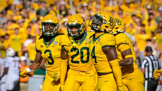 Oct 1, 2022; Waco, Texas, USA; Baylor Bears cornerback Mark Milton (3) and safety Devin Lemear (20) and safety Christian Morgan (4) celebrates making an interception against the Oklahoma State Cowboys during the second half at McLane Stadium. Mandatory Credit: Jerome Miron-USA TODAY Sports