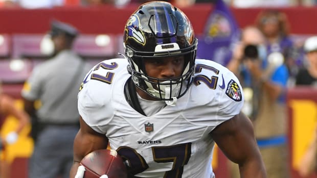 JK Dobbins runs the ball for the Ravens.