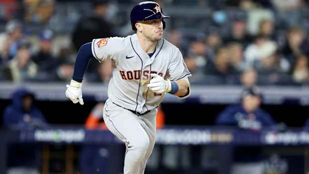 Astros third baseman Alex Bregman runs to first base