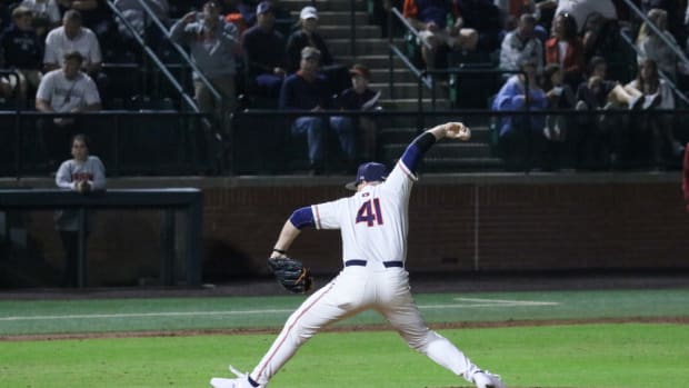 Auburn baseball's John Armstrong throws a pitch vs Alabama.