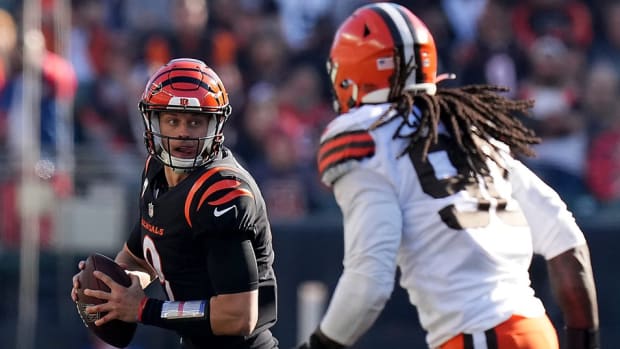 Cincinnati Bengals quarterback Joe Burrow (9) rolls out of the pocket as Cleveland Browns defensive end Jadeveon Clowney (90) and Cleveland Browns defensive tackle Malik Jackson (97) give chase in the second quarter during a Week 9 NFL football game, Sunday, Nov. 7, 2021, at Paul Brown Stadium in Cincinnati. The Cleveland Browns lead the Cincinnati Bengals 24-10 at halftime. Cleveland Browns At Cincinnati Bengals Nov 7