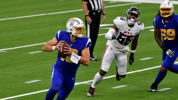 Dec 13, 2020; Inglewood, California, USA; Los Angeles Chargers quarterback Justin Herbert (10) rolls out to throw a pass in the third quarter against the Atlanta Falcons at SoFi Stadium. Mandatory Credit: Robert Hanashiro-USA TODAY Sports