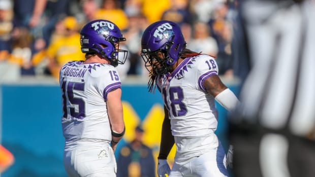 Oct 29, 2022; Morgantown, West Virginia, USA; West Virginia Mountaineers wide receiver Reese Smith (15) celebrates with TCU Horned Frogs wide receiver Savion Williams (18) after connecting for a touchdown pass during the fourth quarter at Mountaineer Field at Milan Puskar Stadium. Mandatory Credit: Ben Queen-USA TODAY Sports