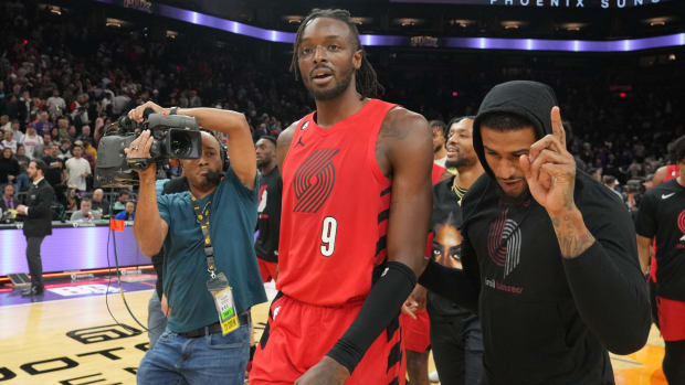 Trail Blazers forward Jerami Grant (9) celebrates with teammates after making a game winning shot against the Suns.