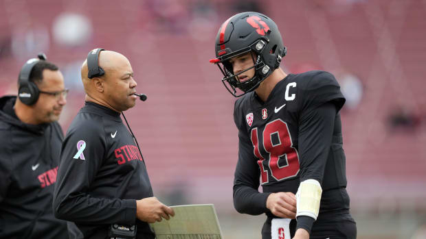 Stanford Cardinal head coach David Shaw (left) talks to quarterback Tanner McKee (18) during the third quarter against the Washington State Cougars at Stanford Stadium.