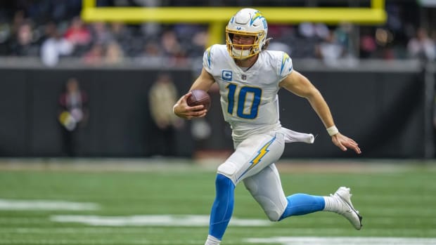 Nov 6, 2022; Atlanta, Georgia, USA; Los Angeles Chargers quarterback Justin Herbert (10) runs the ball against the Atlanta Falcons during the second half at Mercedes-Benz Stadium. Mandatory Credit: Dale Zanine-USA TODAY Sports
