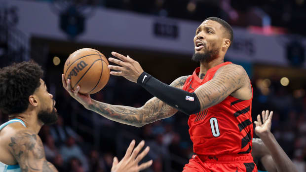 Nov 9, 2022; Charlotte, North Carolina, USA; Portland Trail Blazers guard Damian Lillard (0) drives to the basket against Charlotte Hornets center Nick Richards during the second quarter at Spectrum Center.