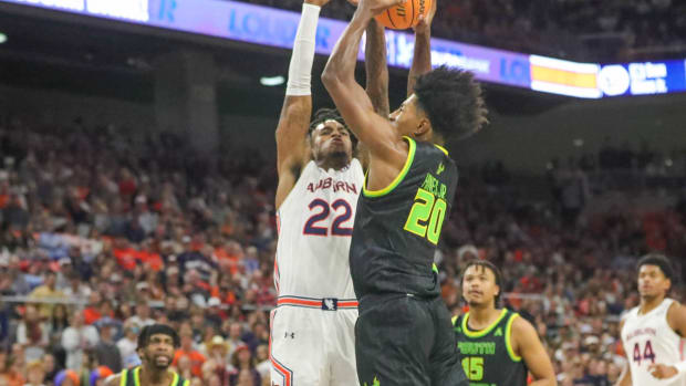 Allen Flanigan defends South Florida for Auburn basketball.