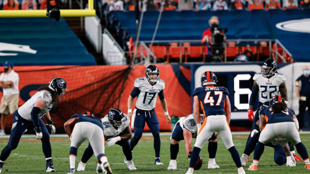 Tennessee Titans quarterback Ryan Tannehill (17) at the line of scrimmage behind offensive tackle Dennis Kelly (71) and offensive guard Nate Davis (64) and center Ben Jones (60) and running back Derrick Henry (22) as Denver Broncos defensive end Jurrell Casey (99) inside linebacker Josey Jewell (47) and defensive end Dre'Mont Jones (93) defend in the first quarter at Empower Field at Mile High.