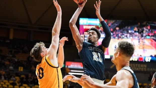 Feb 16, 2019; Laramie, WY, USA; Nevada Wolf Pack forward Jordan Brown (21) shoots against Wyoming Cowboys forward Hunter Thompson (10) during the second half at Arena-Auditorium. Mandatory Credit: Troy Babbitt-USA TODAY Sports

