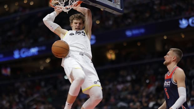 Nov 12, 2022; Washington, District of Columbia, USA; Utah Jazz forward Lauri Markkanen (23) dunks the ball as Washington Wizards center Kristaps Porzingis (6) looks on in the fourth quarter at Capital One Arena. Mandatory Credit: Geoff Burke-USA TODAY Sports