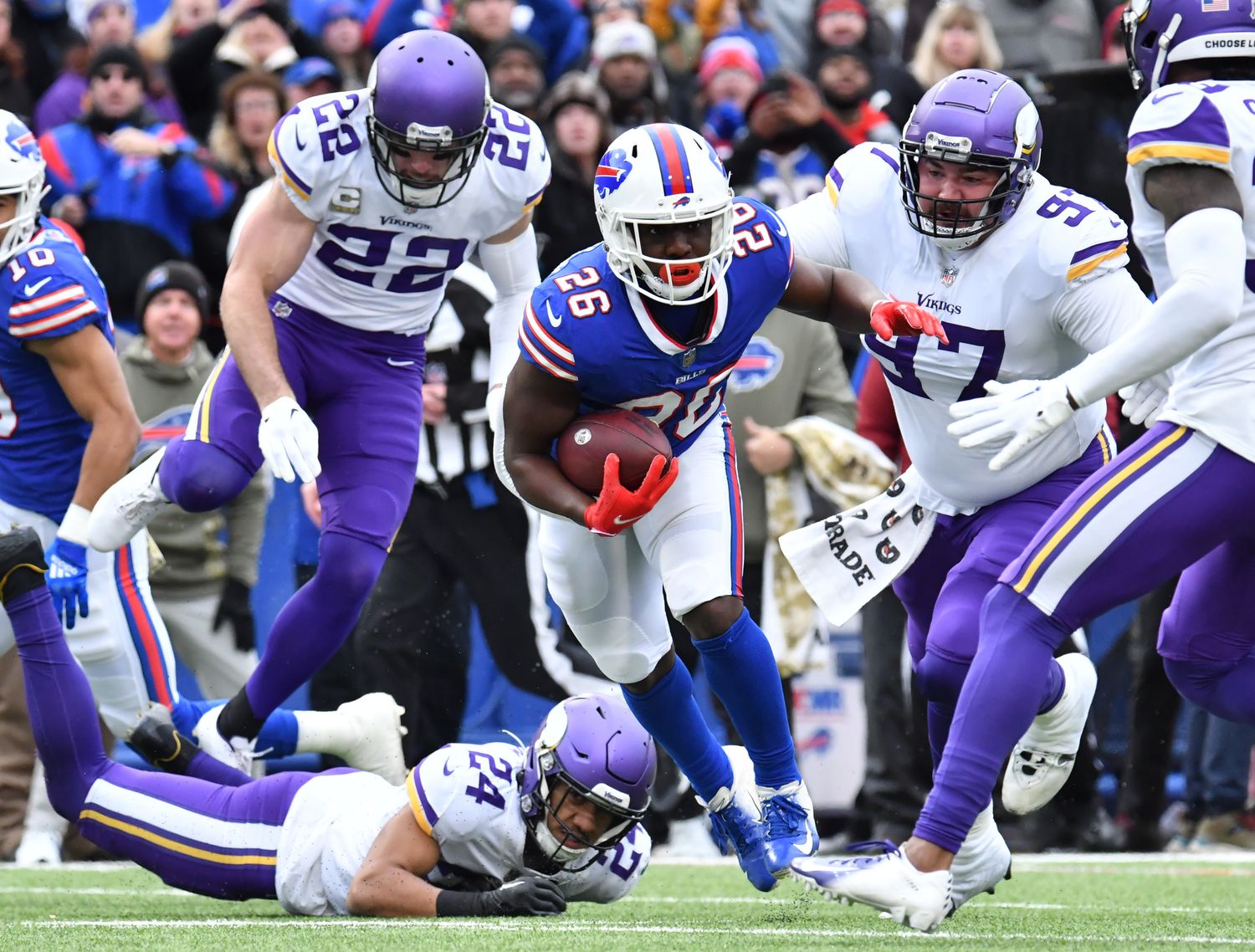 Nov 13, 2022; Orchard Park, New York, USA; Buffalo Bills running back Devin Singletary (26) runs between Minnesota Vikings safety Harrison Smith (22) and defensive tackle Jordan Phillips (97) and safety Camryn Bynum (24) in the first quarter at Highmark Stadium.