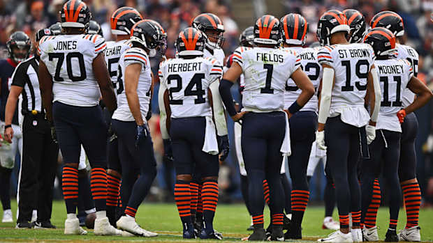 The Bears huddle up wearing throwback uniforms