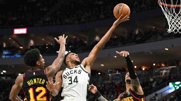 Nov 14, 2022; Milwaukee, Wisconsin, USA; Milwaukee Bucks forward Giannis Antetokounmpo (34) drives to the basket against Atlanta Hawks forward De’Andre Hunter (12) and forward John Collins (20) in the second quarter at Fiserv Forum.