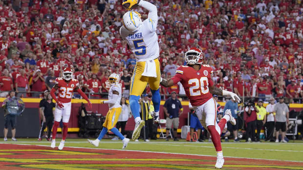 Sep 15, 2022; Kansas City, Missouri, USA; Los Angeles Chargers wide receiver Joshua Palmer (5) catches a touchdown pass against Kansas City Chiefs safety Justin Reid (20) during the second half at GEHA Field at Arrowhead Stadium. Mandatory Credit: Denny Medley-USA TODAY Sports