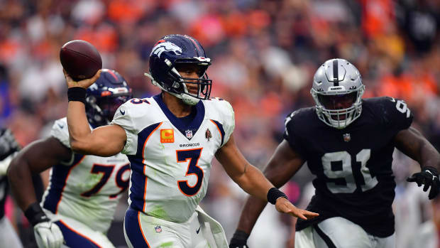 Denver Broncos quarterback Russell Wilson (3) throws as Las Vegas Raiders defensive tackle Bilal Nichols (91) moves in during the second half at Allegiant Stadium.