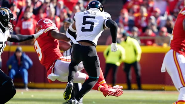 Kansas City Chiefs wide receiver JuJu Smith-Schuster (9) is hit hard by Jacksonville Jaguars safety Andre Cisco (5) during the first half of an NFL football game Sunday, Nov. 13, 2022, in Kansas City, Mo. (AP Photo/Ed Zurga)
