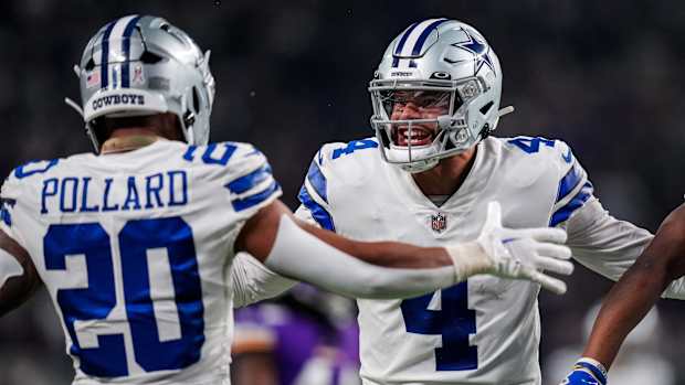 Nov 20, 2022; Minneapolis, Minnesota, USA; Dallas Cowboys quarterback Dak Prescott (4) celebrates a touchdown with running back Tony Pollard (20) during the third quarter against the Minnesota Vikings at U.S. Bank Stadium.