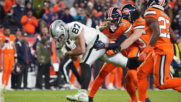 Denver Broncos safety Justin Simmons (31) tackles Las Vegas Raiders tight end Foster Moreau (87) in overtime at Empower Field at Mile High.