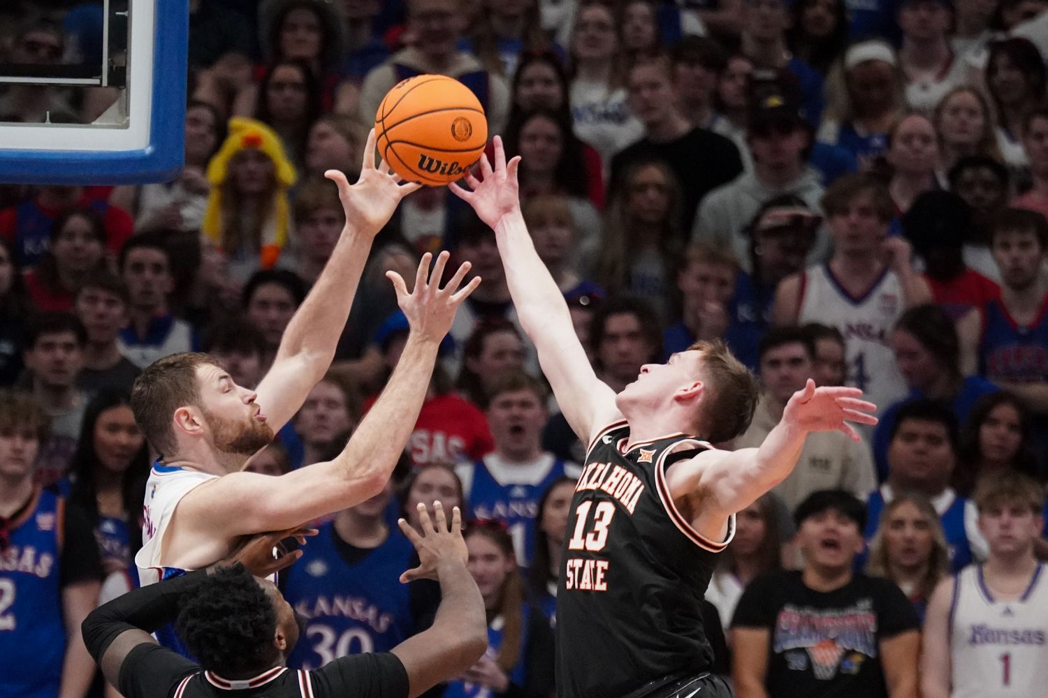 Jan 30, 2024; Lawrence, Kansas, USA; Kansas Jayhawks center Hunter Dickinson (1) and Oklahoma State Cowboys guard Connor Dow (13) fight for a rebound during the first half at Allen Fieldhouse. Mandatory Credit: Denny Medley-USA TODAY Sports