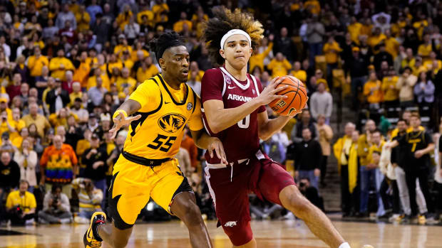 Jan 18, 2023; Columbia, Missouri, USA; Arkansas Razorbacks guard Anthony Black (0) drives against Missouri Tigers guard Sean East II (55) during the second half at Mizzou Arena. Mandatory Credit: Jay Biggerstaff-USA TODAY Sports