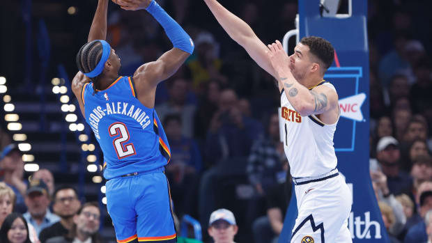 Jan 31, 2024; Oklahoma City, Oklahoma, USA; Oklahoma City Thunder guard Shai Gilgeous-Alexander (2) shoots as Denver Nuggets forward Michael Porter Jr. (1) defends during the first quarter at Paycom Center.© Alonzo Adams-USA TODAY Sports