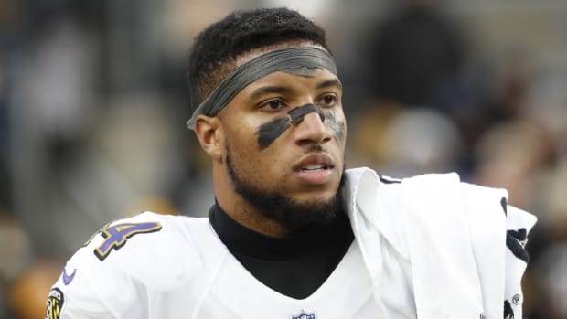 Ravens cornerback Marlon Humphrey looks on from the sidelines during a game.