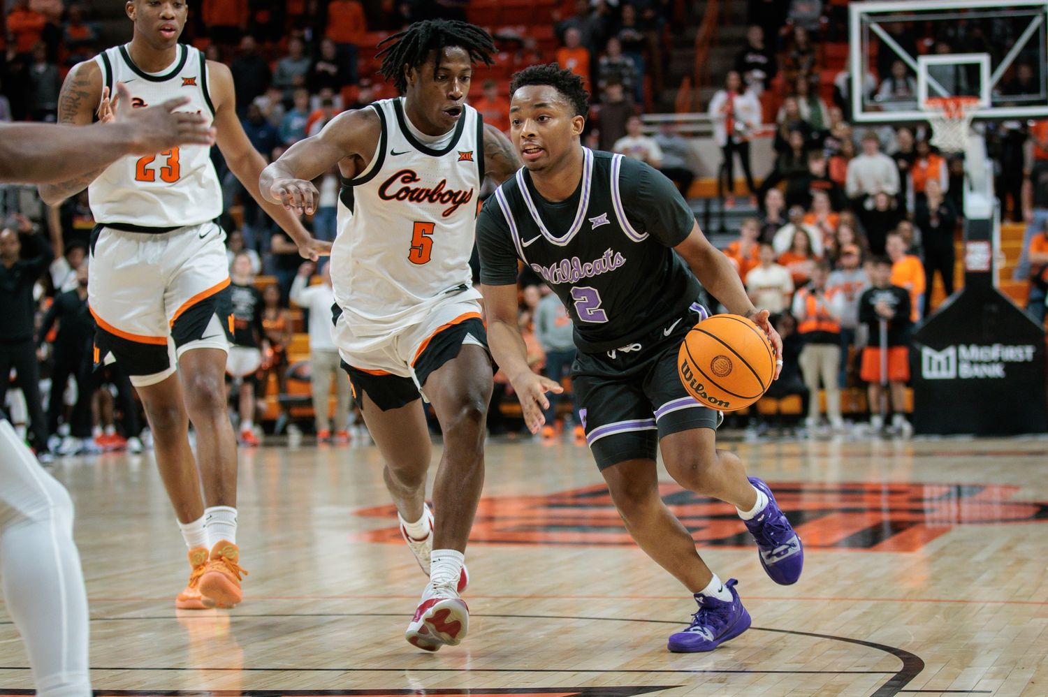 Feb 3, 2024; Stillwater, Oklahoma, USA; Kansas State Wildcats guard Tylor Perry (2) drives around Oklahoma State Cowboys guard Quion Williams (5) during the second half at Gallagher-Iba Arena. Mandatory Credit: William Purnell-USA TODAY Sports