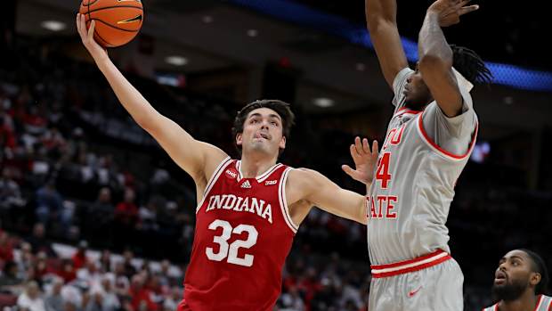 Indiana Hoosiers guard Trey Galloway (32) shoots as Ohio State Buckeyes center Felix Okpara (34) defendsat Value City Arena. 
