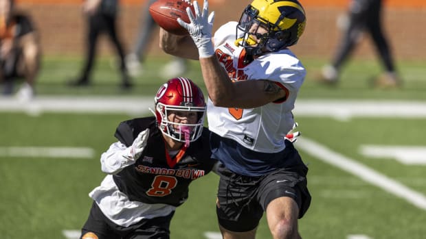 Jan 30, 2024; Mobile, AL, USA; National tight end Aj Barner of Michigan (89) grabs a pass with National defensive back Cole Bishop of Utah (8) pursuing during practice for the National team at Hancock Whitney Stadium. Mandatory Credit: Vasha Hunt-USA TODAY Sports  