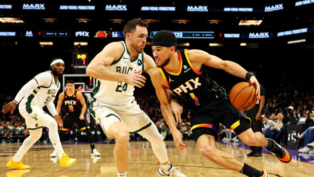Phoenix Suns guard Devin Booker (1) drives to the basket against Milwaukee Bucks guard Pat Connaughton (24)