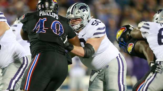 Kansas State senior offensive lineman cooper Beebe (50) keeps Kansas redshirt senior defensive lineman Devin Phillips (40) at bay during the second quarter of Saturday's Sunflower Showdown inside David Booth Kansas Memorial Stadium.