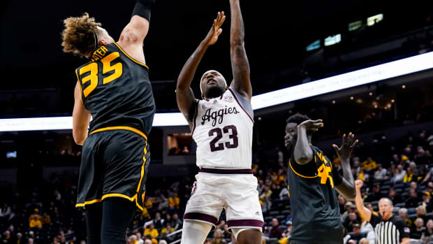 Feb 7, 2024; Columbia, Missouri, USA; Texas A&M Aggies guard Tyrece Radford (23) shoots against Missouri Tigers forward Noah Carter (35) during the second half at Mizzou Arena. Mandatory Credit: Jay Biggerstaff-USA TODAY Sports