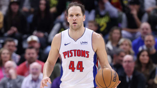 Pistons veteran Bojan Bogdanović dribbles the ball up the court in a game.