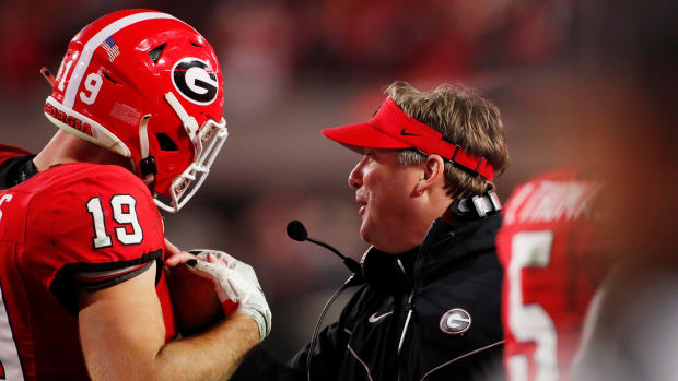 Georgia tight end Brock Bowers (19) celebrates with Georgia coach Kirby Smart after scoring a touchdown during the second half of a NCAA college football game against Ole Miss in Athens, Ga., on Saturday, Nov. 11, 2023. Georgia won 52-17. (Joshua L. Jones / USA TODAY NETWORK).