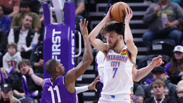 Feb 6, 2024; Salt Lake City, Utah, USA; Oklahoma City Thunder forward Chet Holmgren (7) rebounds over Utah Jazz guard Kris Dunn (11) during the third quarter at Delta Center.