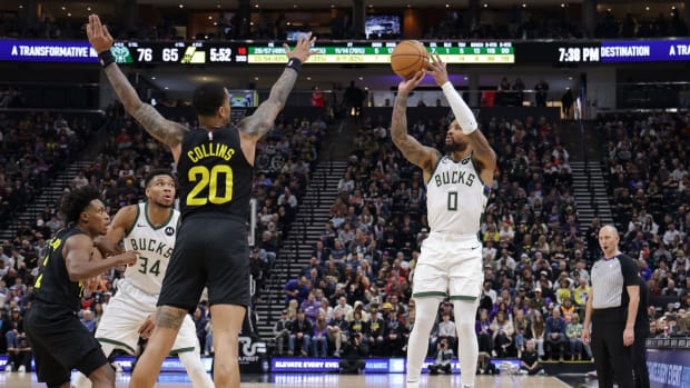 Feb 4, 2024; Salt Lake City, Utah, USA; Milwaukee Bucks guard Damian Lillard (0) shoots a three point shot during the second half against the Utah Jazz at Delta Center.