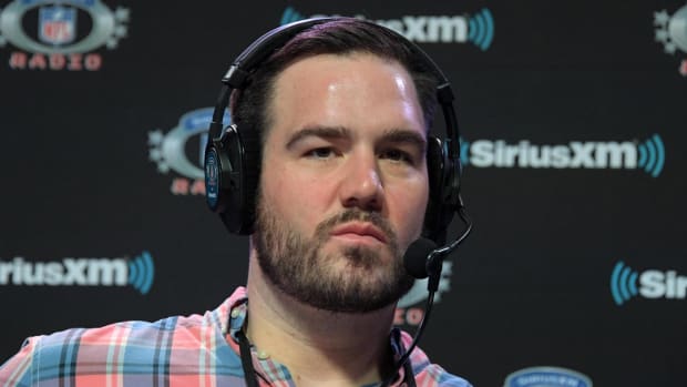 NFL analyst Ross Tucker looks on while broadcasting a radio show.