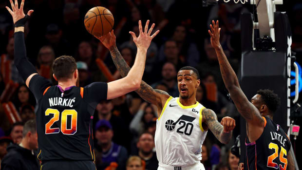 Feb 8, 2024; Phoenix, Arizona, USA; Utah Jazz forward John Collins (20) passes the ball against Phoenix Suns center Jusuf Nurkic (20) and forward Nassir Little (25) during the fourth quarter at Footprint Center. 