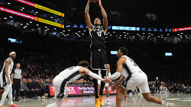Brooklyn Nets center Nic Claxton (33) shoots a layup against San Antonio Spurs small forward Cedi Osman (16) and San Antonio Spurs small forward Keldon Johnson (3) during the second half at Barclays Center.