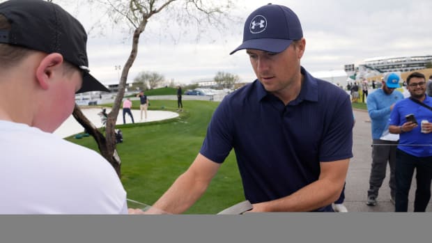 Jordan Spieth signs an autograph during the WM Phoenix Open at TPC Scottsdale.