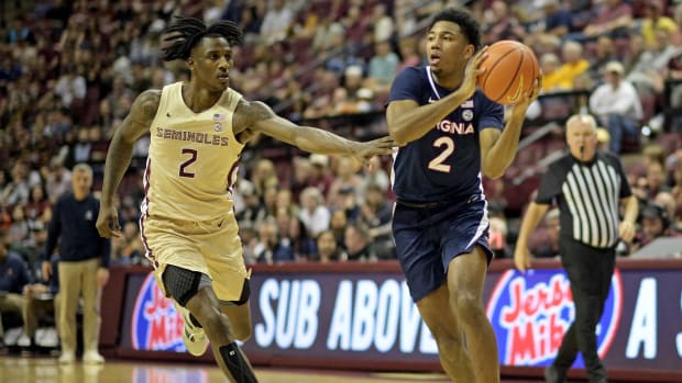 Virginia Cavaliers guard Reece Beekman (2) drives to the net as Florida State Seminoles forward Jamir Watkins (2) defends during the first half at Donald L. Tucker Center.